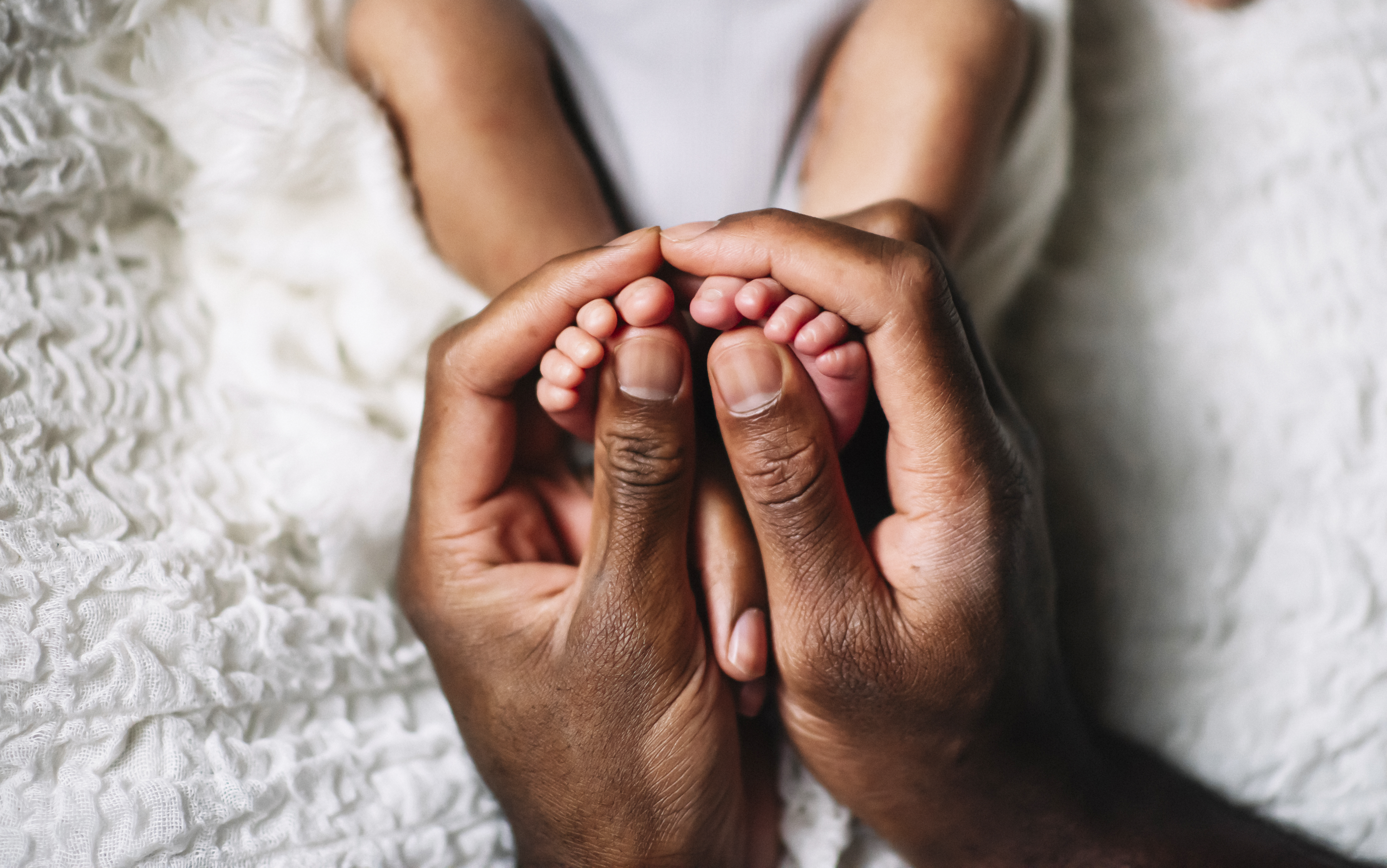 GettyImages-1361926960-Hands_Baby_Feet_Closeup-RET