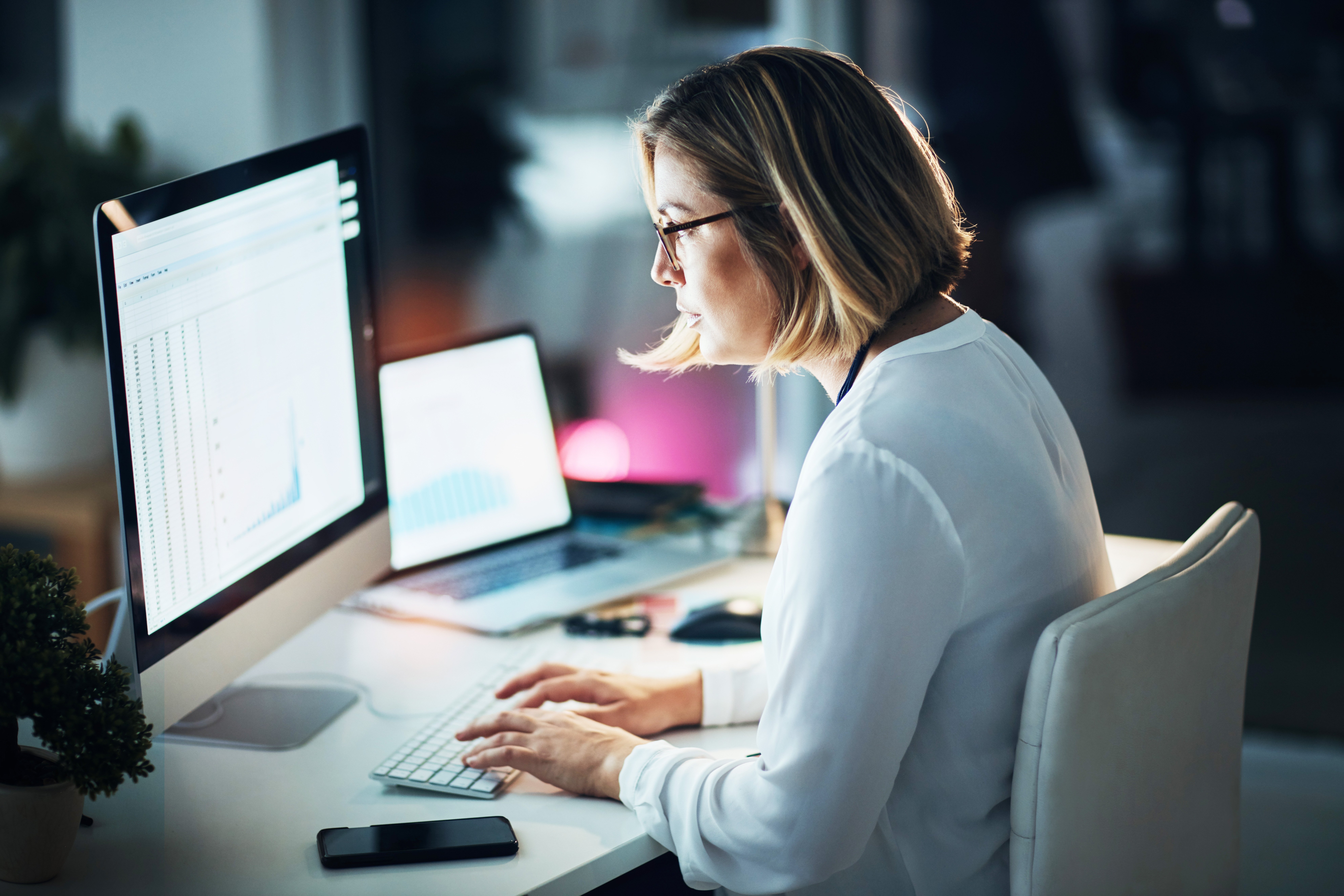 Tech analyst in office with graphs, charts and market research to monitor online growth